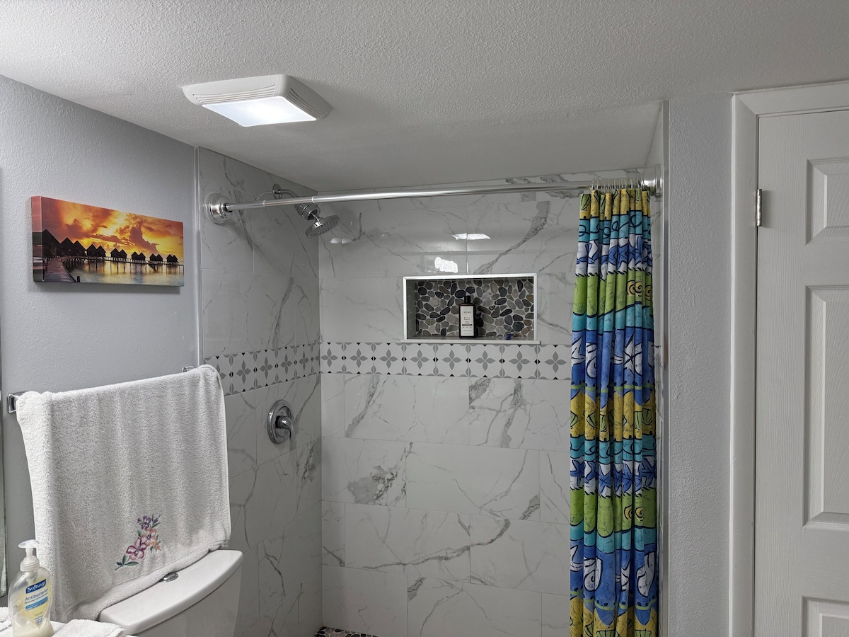 Bathroom with a shower and tub